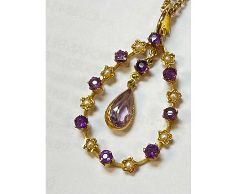 15CT GOLD AMETHYST & SEED PEARL PENDANT, with central drop pear shaped amethyst, on yellow metal chainProvenance: private col