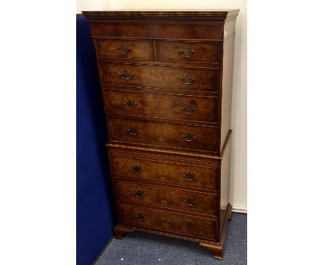 A reproduction burr maple, walnut, mahogany and inlaid chest on chest, two short over six long drawers and a brushing slide, 