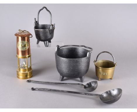 Various industrial metalware including two iron cauldrons, a three footed brass railway cauldron marked 1521 with lion passan