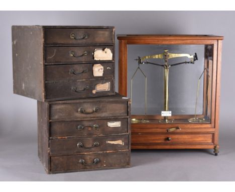 A cased set of brass balance scales for upto 250g 49 cm x 42 cm x 23 cm together with two banks of collectors drawers, each c