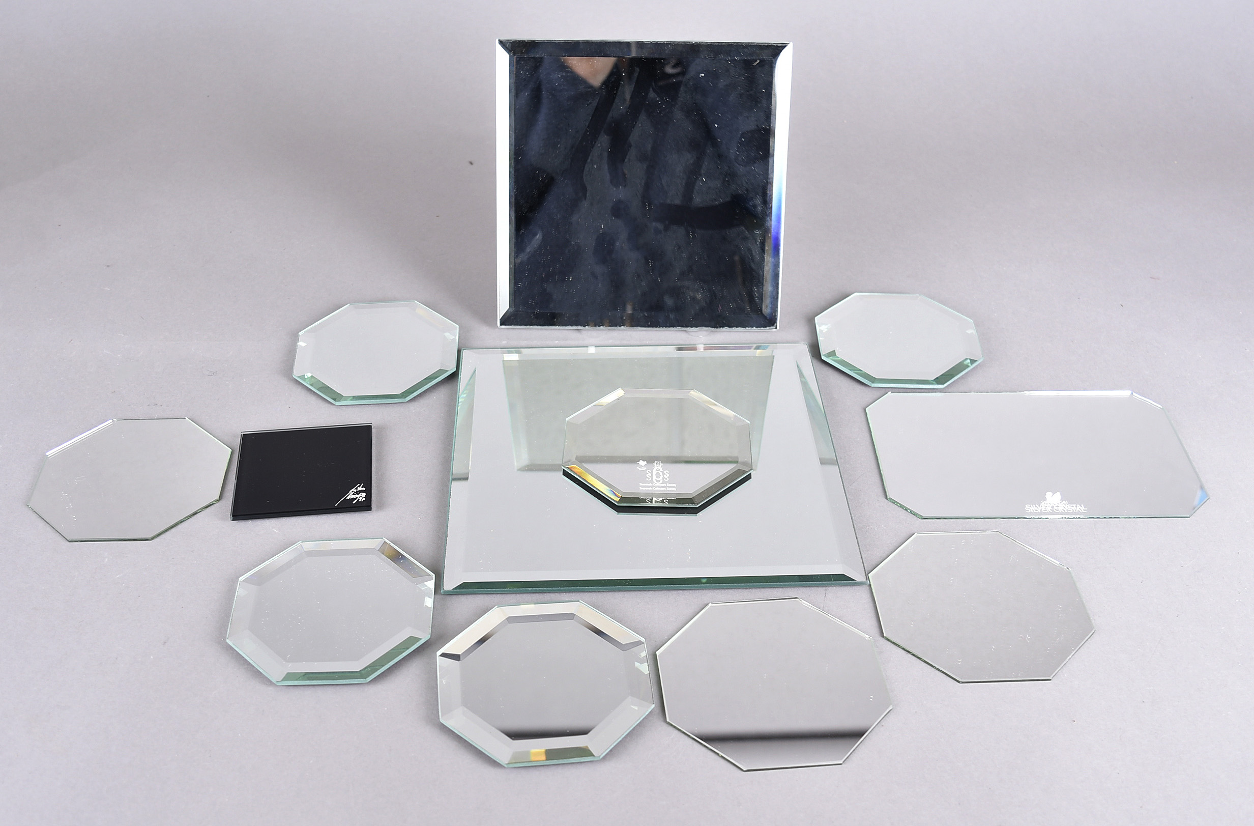 A collection of mirrored display stands, some by Swarovski, various