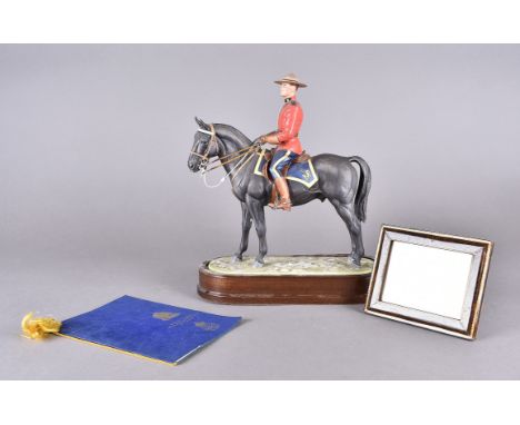 A Royal Worcester figurine, Royal Canadian Mounted Policeman modelled by Doris Lindner, with plinth and certificate limited e