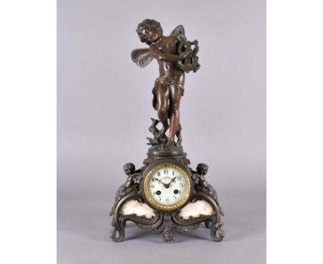 A spelter mantel clock, with eight day movement surmounted by a winged cherub playing the lyre, after Moreau, af