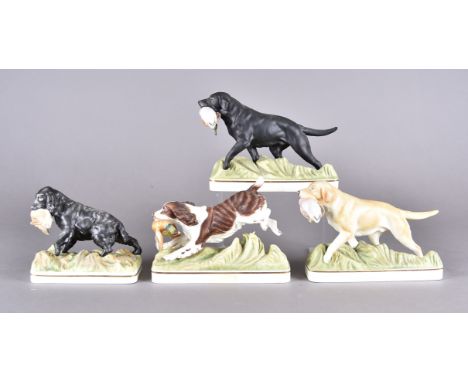 Four Royal Worcester bisque figures of gundogs with game, modelled by Doris Lindner including Labrador, Yellow Labrador, Spri