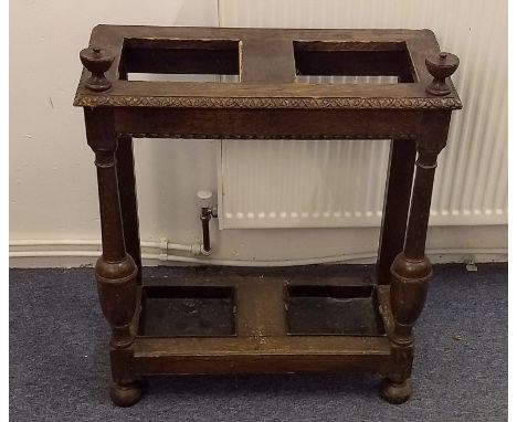 An oak two section stick stand, complete with metal trays, 65 cm wide x 36 cm deep x 78 cm high