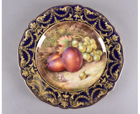 A Royal Worcester porcelain fruit patterned plate, by R Seabright, the painted plate decorated with plums and grapes, cobalt 
