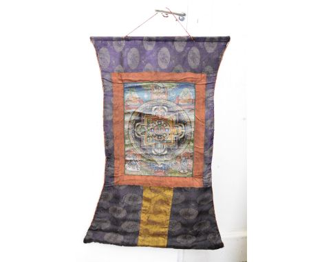An early 20th Century Indo Chinese wall hanging, the silk Chinese surround centred with painted Hindu panel, 79 cm x 49 cm