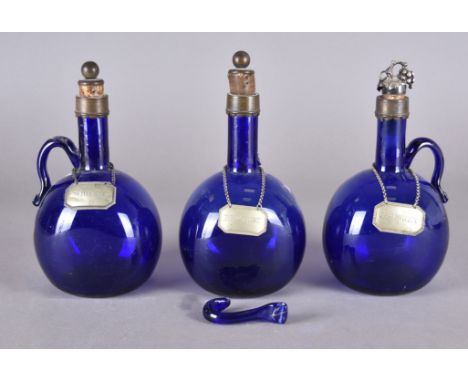 Three Bristol blue glass decanters, each with metalware collars and silver plated labels, one decanter handle af, 24 cm high