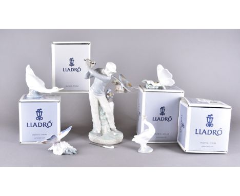 Four Lladro butterflies, boxed, a Lladro model of a golfer and two Nao models of swans