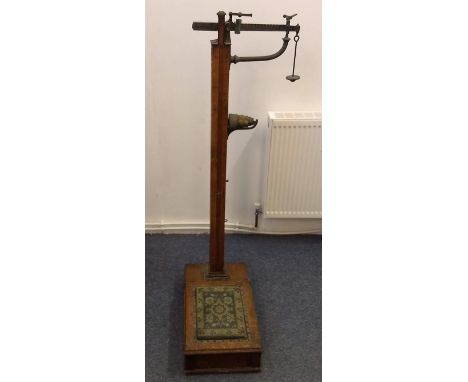 An Edwardian oak doctor's scales and measure by W &amp; T Avery Birmingham, with original weights