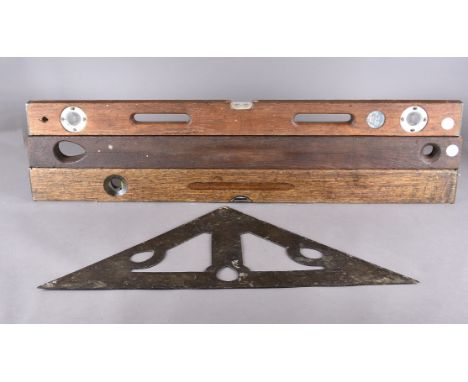 A Victorian cast iron mason's spirit level, of triangular shape, with cut out design, with indistinct engraved lines, perhaps