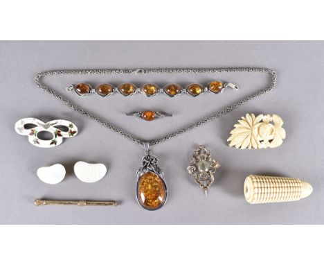 A collection of amber jewels, comprising an oval pendant with silver chain, silver bar, silver bracelet. Together with an ivo