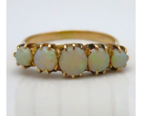 A yellow metal five stone opal ring, tests electronically as 9ct gold, 2.7g, size O