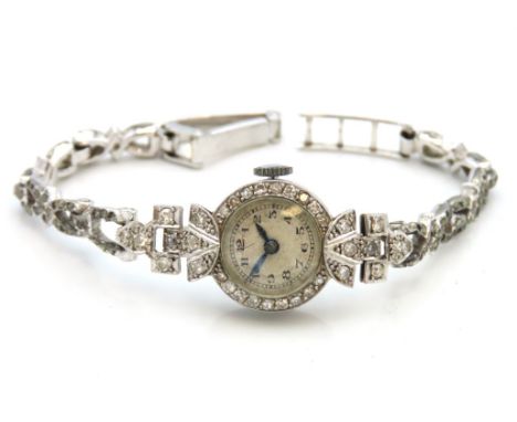 An art deco 1920's ladies platinum wrist watch (from case to shoulder & first link), encrusted with approx. 0.45ct of diamond
