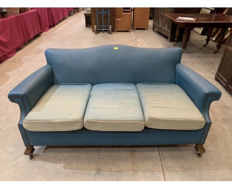 A 1930s three seater sofa upholstered in blue faux leather. 64' wide