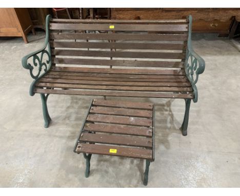 A cast iron and wood slatted garden bench and table