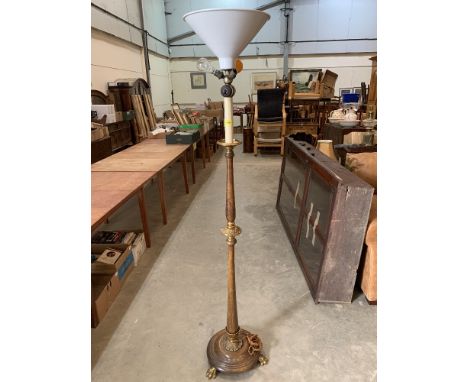 An early 20th century mahogany and gilt brass mounted hotel lamp standard on paw feet