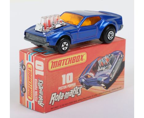 Matchbox Superfast 10b Piston Popper with Dark Blue body and Dark Amber glass, model is mint in a mint later 2nd issue J box