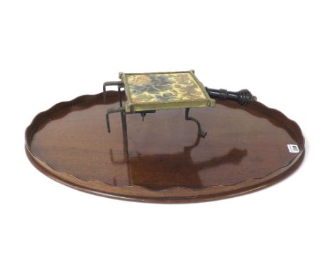 Flame mahogany oval gallery tray, 25" long; together with an iron and brass trivet fitted with a ceramic tile (2)
