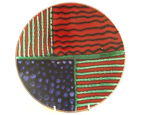 Poole Pottery charger by Nicola Massarella, decorated with stripes and polka dots upon a red ground, signed to the base, 10.5