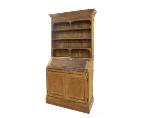 Pitch pine bureau bookcase, the raised architectural Delft rack with turned columns upon a base fitted with a fall front encl