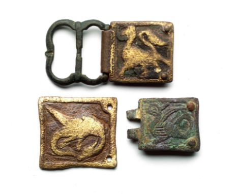 A COLLECTION OF EARLY MEDIEVAL COPPER-ALLOY RELIEF-DECORATED HORSE-HARNESS PENDANTS AND MOUNTS including an heraldic shield w