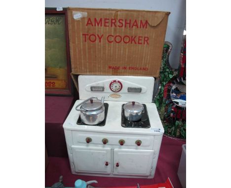 Amersham Toys, vintage tin plate toy cooker having detachable back, with kettle, pan, and original box, 31cm wide.