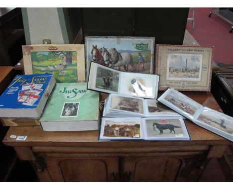 Vintage wooden jigsaw puzzles Victory and Chad Valley examples together with four filled albums with dog themed postcards. 1 
