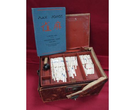 An Early XX Century Mah Jong Set, the leather travelling case with five lift-out trays containing bone and bamboo tiles and s