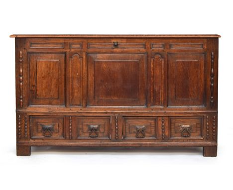 An 18th century and later oak three panel mule chest, moulded hinged top, over three fielded panels flanked by applied mouldi