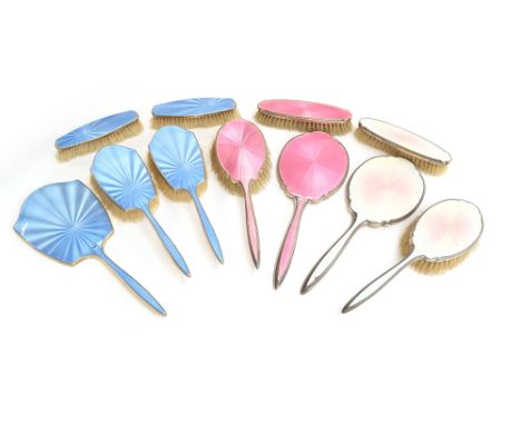 A silver and pink guilloche enamel dressing table set by Harrods, Birmingham 1938, comprising two hair brushes, two clothes b
