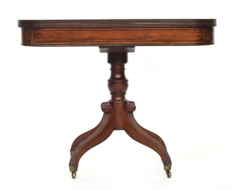 A William IV mahogany tea table, c.1830, foldover top on turned column, hipped and reeded supports on brass casters, 91cm wid