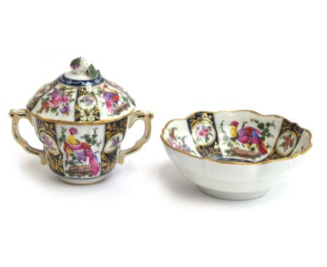 An 18th century Worcester twin handled cup and cover, hand painted with fancy birds and floral sprays on a blue ground, finia