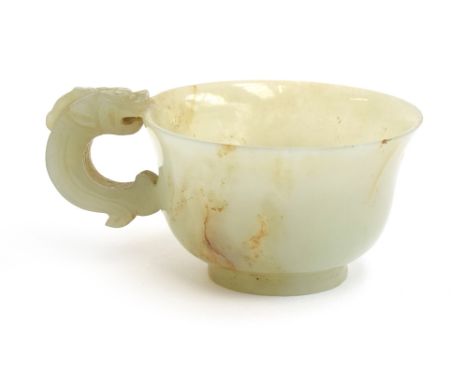 A Chinese celadon and russet jade libation cup, the handle in the form of a dragon, 4cm high 