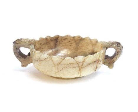 A Chinese mutton fat and mottled grey jade twin handled cup, of shallow lotus form with twin dragon form handles, 9cm wide 2.