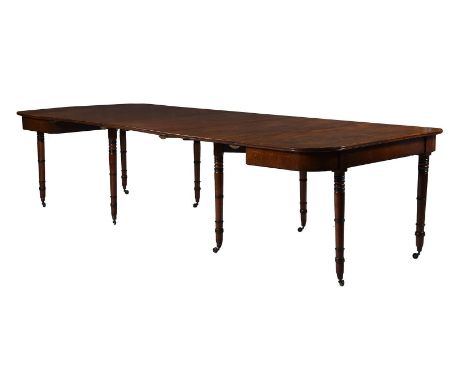 A Regency mahogany and parcel ebonised extending dining table, c.1820, with three additional leaf insertions, 232cm long, 122