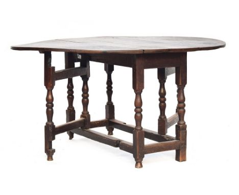 An 18th century oak oval gateleg table, on block and baluster turned supports, 122cm wide, 151cm long open, 75cm high 