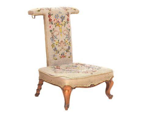 A small high backed tapestry chair with serpentine carving to the back legs 