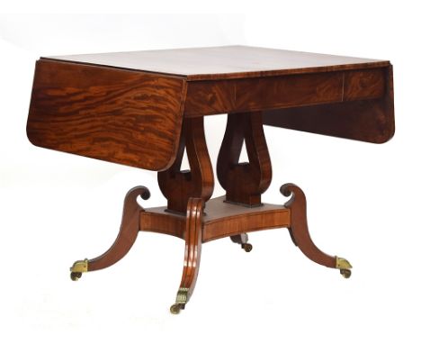 A Regency mahogany sofa table, drop leaf to each end, single drawer, raised on lyre supports and four hipped sable legs with 