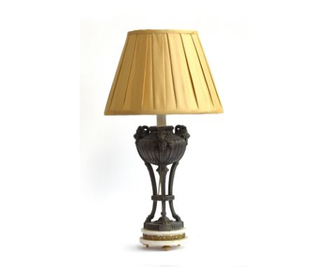 A cast metal, parcel gilt, and marble table lamp in the form of a censor, with three rams heads and hoof feet, on circular ma