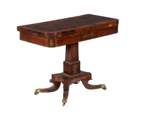 A George IV rosewood and brass inlaid card table, c.1825, the folding top enclosing a baize playing surface and quadripartite
