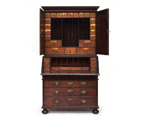 A George II oak bureau bookcase estate cupboard, moulded pediment over two fielded panel doors, opening to splendid fitted in