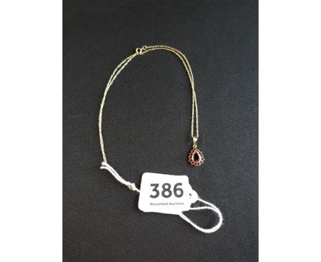 9 CARAT GOLD GARNET PENDANT ON 9 CARAT GOLD CHAIN