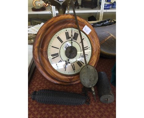 A circular wooden cased postman's alarm clock together with weights and pendulum.