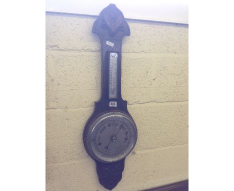 An early 20th century oak cased wall barometer.