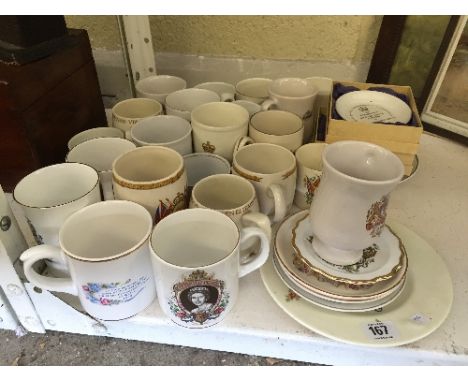 A shelf containing a large quantity of various commemorative china jugs.