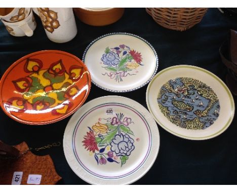 Four various Poole Pottery plates and dishes including a Poole Harbour Map plate.