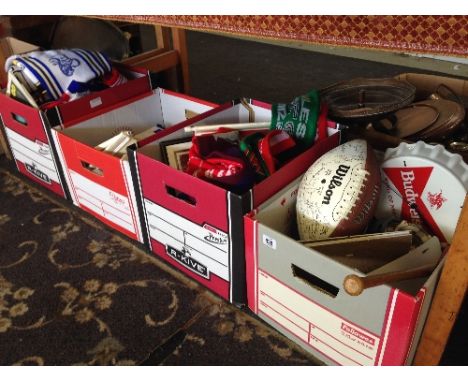 Four boxes containing a large quantity of various sporting memorabilia items including football scarves, pennants and other s