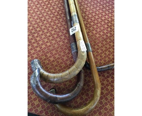 Three various late 19th century silver mounted walking sticks together with a 9 carat gold mounted walking stick.