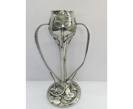 An Art Nouveau twin handled pewter vase by A. E. Williams, decorated with stylised flowers (one handle repaired).